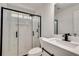 Modern bathroom with a glass-enclosed shower, white marble tile, and sleek black fixtures at 2216 Marbut Farms Trce, Lithonia, GA 30058
