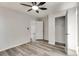 A bedroom featuring neutral walls, gray wood-look flooring, with an open closet and a ceiling fan at 2216 Marbut Farms Trce, Lithonia, GA 30058