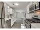 Contemporary kitchen with stainless appliances, white cabinets, and an open concept floorplan at 2216 Marbut Farms Trce, Lithonia, GA 30058