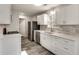 Updated kitchen boasts white cabinets, stainless appliances, and contemporary backsplash at 2216 Marbut Farms Trce, Lithonia, GA 30058