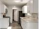 Well-lit kitchen featuring white cabinetry, stainless steel appliances, and modern backsplash at 2216 Marbut Farms Trce, Lithonia, GA 30058