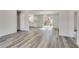 Open-concept space with wood floors leading to a bright kitchen and dining area at 2216 Marbut Farms Trce, Lithonia, GA 30058