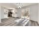 Bright living room features an open floor plan, modern light fixture, and sliding glass doors at 2216 Marbut Farms Trce, Lithonia, GA 30058