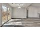 Spacious living room featuring sleek gray flooring and sliding glass doors to outdoor space at 2216 Marbut Farms Trce, Lithonia, GA 30058