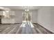 Open concept dining area with modern flooring, adjacent to a kitchen and bright sliding glass door at 2216 Marbut Farms Trce, Lithonia, GA 30058