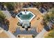 Aerial view of community pool, amenities, parking, and surrounding trees at 5960 Camelia Dr, Douglasville, GA 30135