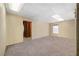 Spacious carpeted basement area with wood-paneled walls, window, and doorway at 5960 Camelia Dr, Douglasville, GA 30135
