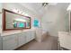 Stylish bathroom featuring double sinks, a bathtub, and a window providing natural light and ventilation at 5960 Camelia Dr, Douglasville, GA 30135