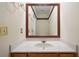 Bathroom vanity features a granite countertop, modern faucet and framed mirror at 5960 Camelia Dr, Douglasville, GA 30135