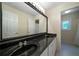 Modern bathroom with a double sink vanity, large mirror, and ample lighting at 5960 Camelia Dr, Douglasville, GA 30135