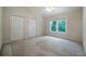 This bedroom features natural light from the window and a ceiling fan at 5960 Camelia Dr, Douglasville, GA 30135