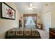 Welcoming bedroom with a window view, ceiling fan, and a comfortable-looking bed at 5960 Camelia Dr, Douglasville, GA 30135