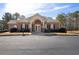 Exterior view of the brick community clubhouse with ample parking at 5960 Camelia Dr, Douglasville, GA 30135