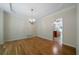 Elegant dining room with hardwood floors, a chandelier, and an open doorway to another room at 5960 Camelia Dr, Douglasville, GA 30135