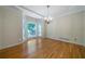 Bright dining room with hardwood floors, large bay window, chandelier, and neutral paint at 5960 Camelia Dr, Douglasville, GA 30135