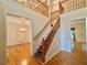 Grand two-story entryway with staircase, hardwood floors, and chandelier view into a living space at 5960 Camelia Dr, Douglasville, GA 30135