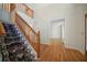 Inviting foyer featuring a staircase with a carpet runner and gleaming hardwood floors at 5960 Camelia Dr, Douglasville, GA 30135