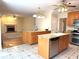 Spacious kitchen with double islands, granite countertops, stainless steel appliances, and tile flooring at 5960 Camelia Dr, Douglasville, GA 30135