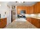Kitchen showcasing stainless steel appliances, granite countertops, and access to adjacent dining area at 5960 Camelia Dr, Douglasville, GA 30135