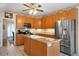 Well-lit kitchen with stainless steel refrigerator, tile floors, and center island with sink at 5960 Camelia Dr, Douglasville, GA 30135