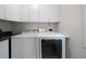 Bright laundry room featuring a washing machine, dryer, and overhead storage cabinets at 5960 Camelia Dr, Douglasville, GA 30135