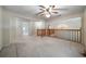 Spacious loft with a ceiling fan and chandelier, providing an open and inviting atmosphere at 5960 Camelia Dr, Douglasville, GA 30135