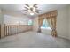 Cozy loft area with large window, ceiling fan and chandelier, perfect for relaxing or entertaining at 5960 Camelia Dr, Douglasville, GA 30135