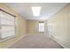 Bright room with carpet, paneled walls, and natural light from two windows at 5960 Camelia Dr, Douglasville, GA 30135