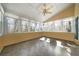 Sunroom featuring multiple windows with outdoor views and neutral tile flooring at 5960 Camelia Dr, Douglasville, GA 30135