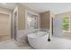 A gorgeous bathroom features a soaking tub, a walk-in shower, and high-end finishes at 133 Frontier Way, Mcdonough, GA 30253