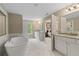 A luxurious bathroom suite offers double vanities, soaking tub, and designer tile at 133 Frontier Way, Mcdonough, GA 30253