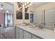 Bathroom featuring double sinks, a large mirror, modern fixtures, and access to a brightly lit bedroom at 133 Frontier Way, Mcdonough, GA 30253