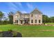 Stunning brick two-story home featuring a lush green lawn, classic architecture, and inviting front entrance at 133 Frontier Way, Mcdonough, GA 30253