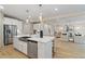 Bright kitchen with stainless steel appliances and an island featuring pendant lighting at 133 Frontier Way, Mcdonough, GA 30253