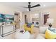 Loft area with a TV, a ceiling fan, laundry area, and comfortable seating, ideal for entertainment or relaxation at 133 Frontier Way, Mcdonough, GA 30253