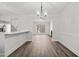 Open-concept dining area with hardwood floors, pendant lighting and connecting living spaces at 2111 Glenwood Downs Dr, Decatur, GA 30035