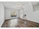 Spacious living room with large windows, hardwood floors, and modern staircase at 2111 Glenwood Downs Dr, Decatur, GA 30035