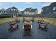 Community fire pit with Adirondack chairs in a gravel setting at 51 Hydrangea Unit 74 Way, Auburn, GA 30011