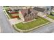 Aerial view of a well-manicured property featuring a two-story brick home, green lawn, and fenced backyard at 106 Dustin Dr, Stockbridge, GA 30281