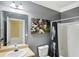 Bathroom showcasing a bathtub with shower and featuring grey walls and football artwork at 106 Dustin Dr, Stockbridge, GA 30281