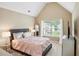 Vaulted ceiling bedroom boasts great natural light with a plush bed and stylish decor at 106 Dustin Dr, Stockbridge, GA 30281