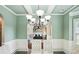 Elegant dining room featuring a coffered ceiling, chandelier, and views of adjoining rooms at 106 Dustin Dr, Stockbridge, GA 30281