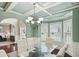 Bright dining room with coffered ceiling, chandelier, and large windows for ample natural light at 106 Dustin Dr, Stockbridge, GA 30281