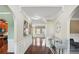 Elegant entryway with hardwood floors, decorative molding, and a view of the kitchen and living spaces at 106 Dustin Dr, Stockbridge, GA 30281