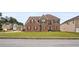 Charming brick two-story home with manicured lawn and traditional architectural details at 106 Dustin Dr, Stockbridge, GA 30281