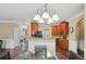 Bright eat-in kitchen area with modern lighting, granite countertops, and wood cabinets and flooring at 106 Dustin Dr, Stockbridge, GA 30281