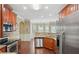 Well-equipped kitchen with stainless steel appliances, granite countertops, and cherry-wood finished cabinetry at 106 Dustin Dr, Stockbridge, GA 30281
