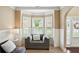 Cozy sitting area with a comfortable armchair, bay window, and elegant decor at 106 Dustin Dr, Stockbridge, GA 30281