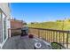 Back deck with grill, chairs, and a view of green space at 113 Brianna Way, Woodstock, GA 30188