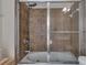 Tiled bathroom shower-tub combo with glass doors and jets at 113 Brianna Way, Woodstock, GA 30188